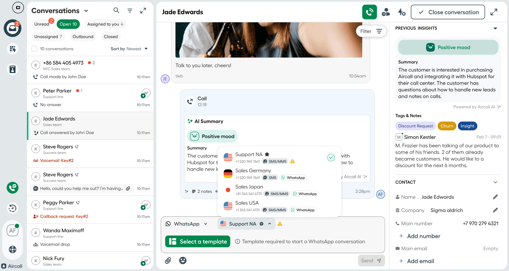 An active conversation view in Aircall Workspace with a dropdown showing available sender numbers — including Support NA, Sales Germany, Sales Japan, and Sales USA — each with icons for SMS, MMS, and WhatsApp. Some numbers show warnings for unavailable messaging types..png